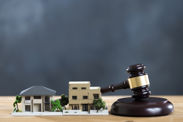家の模型と裁判官がもつハンマーがある